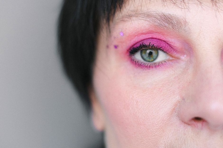 Detailed close-up of eye makeup showcasing intricate design and vibrant colors.