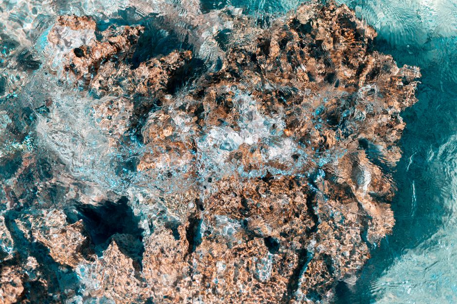 Stunning aerial view of rocky formations under clear turquoise water, Rovinj, Croatia.