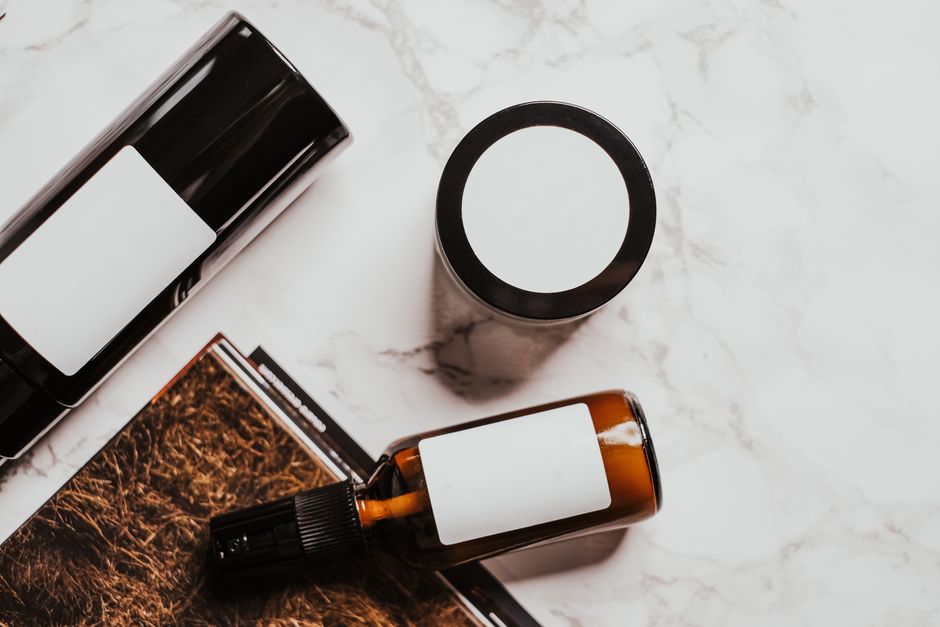 A flat lay of skincare products on a marble surface, showcasing a minimalistic and modern design.