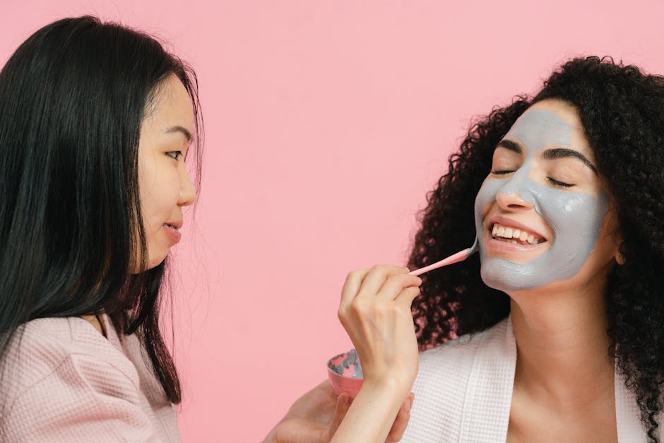 Two women enjoying a relaxing facial clay mask session in a studio setting.
